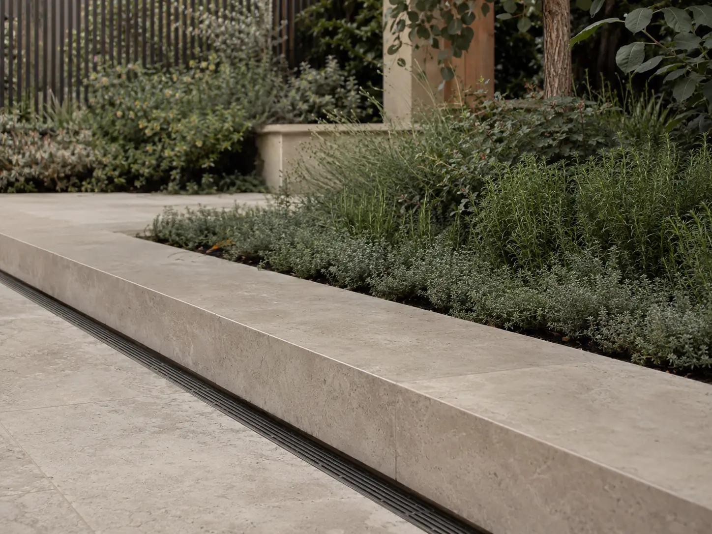 Precise natural stone landscape construction with integrated drainage and planting edge